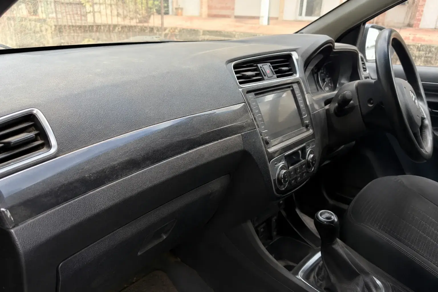 Car interior showing heavy dust buildup
