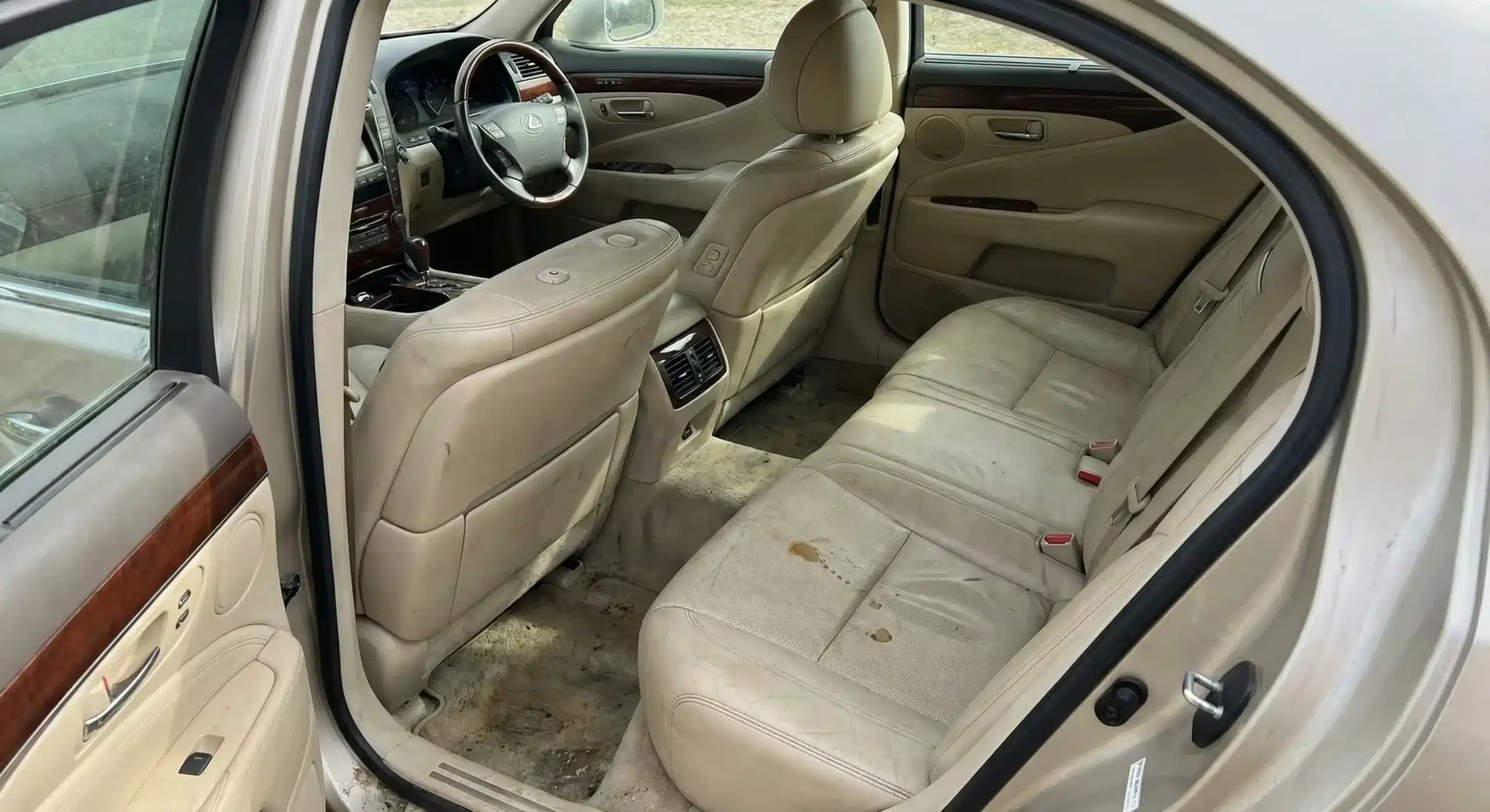 Luxury car interior before detailing in Chennai showing dust and grime